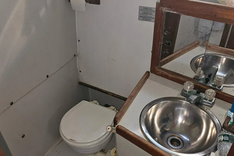 Slide: The Image of Bathroom interior of 1988 Rampage 31 Express boat with sink and toilet. - 18