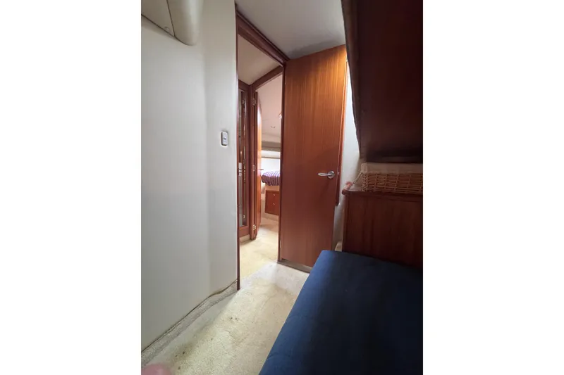 Slide: The Image of Interior view of 2006 Riviera 37 Flybridge yacht cabin with open wooden door. - 22