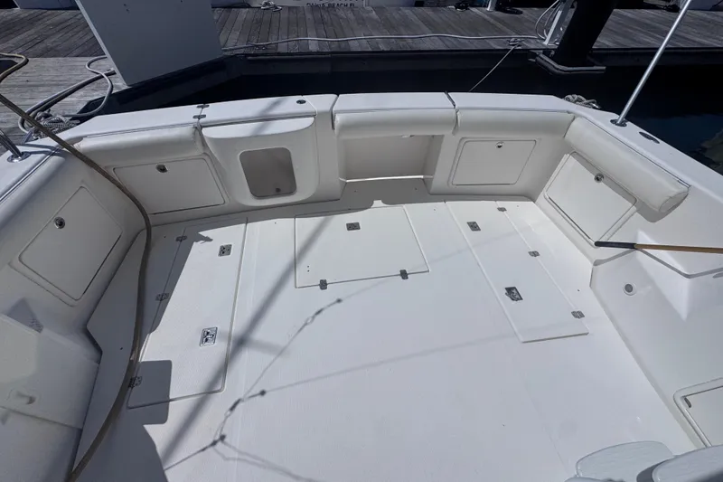 Slide: The Image of Spacious deck of 2006 Riviera 37 Flybridge yacht, featuring storage compartments and seating. - 25