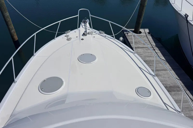 Slide: The Image of Bow view of 2006 Riviera 37 Flybridge yacht docked at marina. - 35