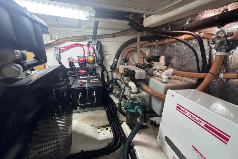 Slide: The Image of Engine room of 2006 Riviera 37 Flybridge with visible wiring and equipment. - 37
