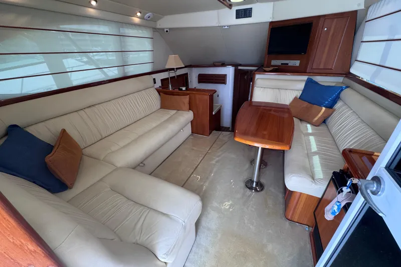 Slide: The Image of Luxurious interior of 2006 Riviera 37 Flybridge yacht with plush seating and wooden accents. - 6