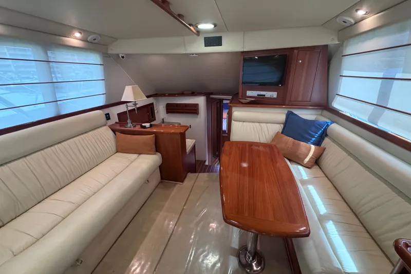 Slide: The Image of Luxurious interior of a 2006 Riviera 37 Flybridge yacht with elegant seating and wooden accents. - 8
