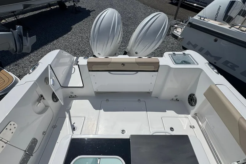 Slide: The Image of 2026 Edgewater 262CC boat interior with dual engines and seating area. - 10