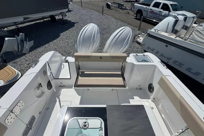 Slide: The Image of 2026 Edgewater 262CC boat interior with seating and dual outboard motors. - 11