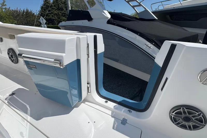 Slide: The Image of 2026 Edgewater 262CC boat with open side door and built-in cooler. - 14