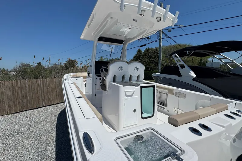 Slide: The Image of 2026 Edgewater 262CC boat with sleek design and modern amenities, docked outdoors. - 15
