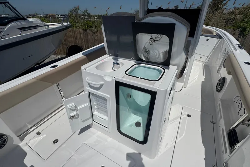 Slide: The Image of 2026 Edgewater 262CC boat interior with sink and storage compartments. - 19