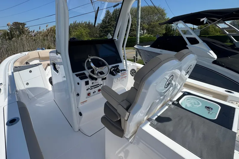 Slide: The Image of 2026 Edgewater 262CC boat interior with modern helm and seating. - 26