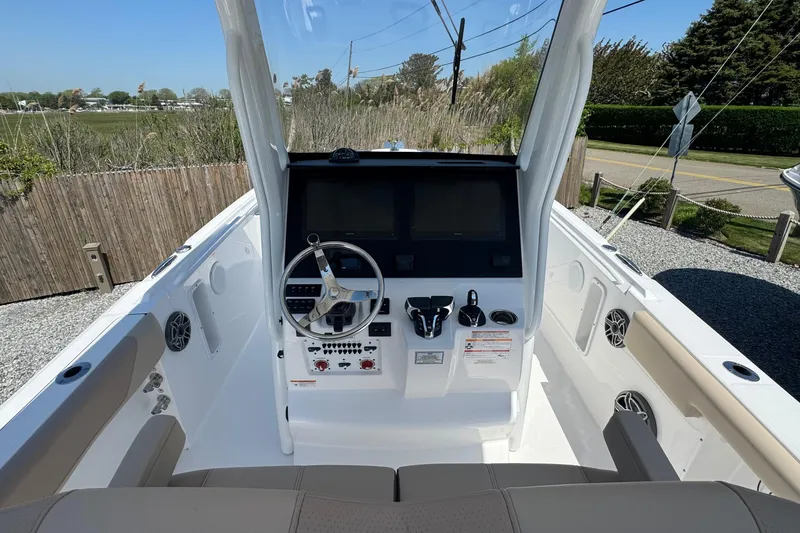 Slide: The Image of 2026 Edgewater 262CC boat cockpit with steering wheel and control panel. - 27