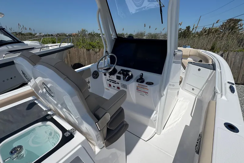 Slide: The Image of 2026 Edgewater 262CC boat interior with helm, seating, and control panel. - 28