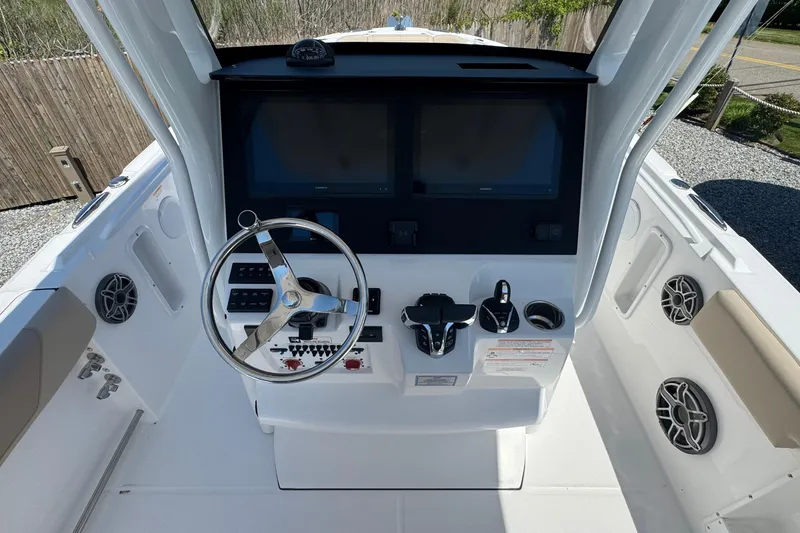 Slide: The Image of 2026 Edgewater 262CC boat dashboard with steering wheel and dual screens. - 29