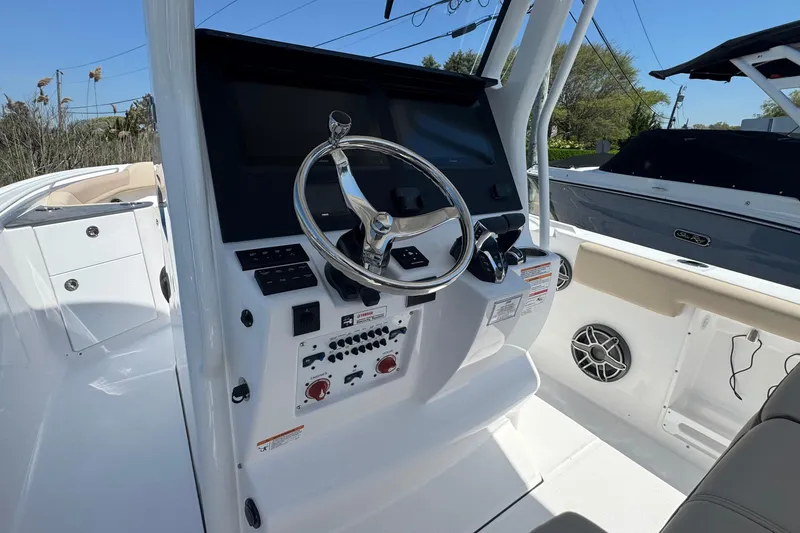Slide: The Image of 2026 Edgewater 262CC boat helm with steering wheel and control panel. - 30