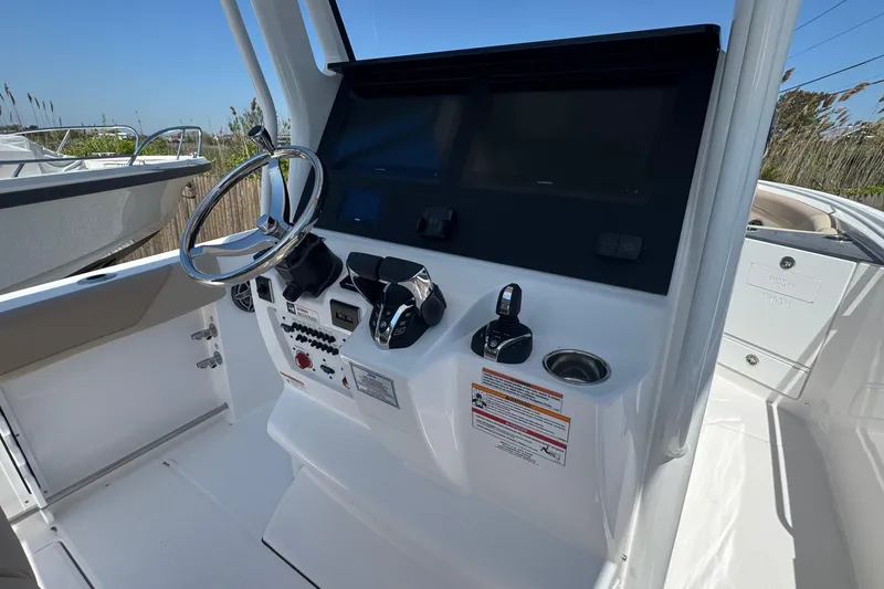 Slide: The Image of Helm of 2026 Edgewater 262CC boat with steering wheel and control panel. - 31