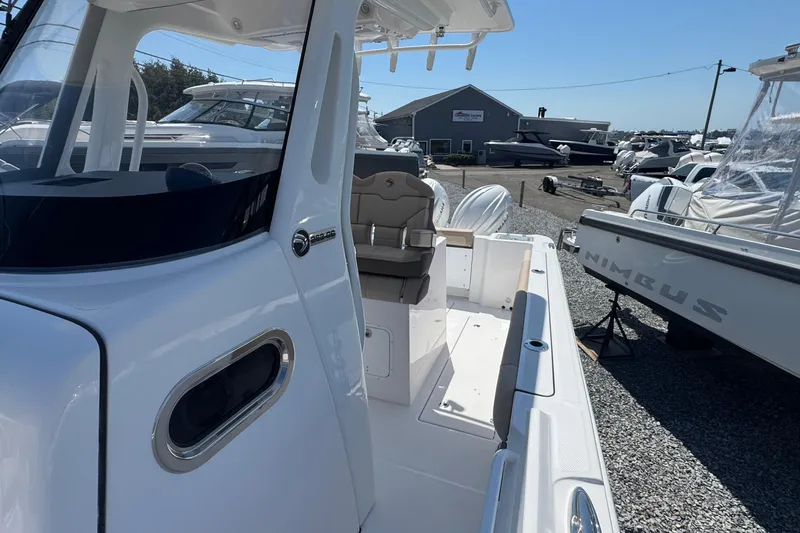 Slide: The Image of 2026 Edgewater 262CC boat at a marina, showcasing sleek design and modern features. - 36