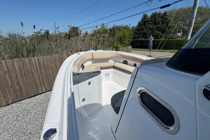 Slide: The Image of 2026 Edgewater 262CC boat interior with beige seating and sleek design. - 38