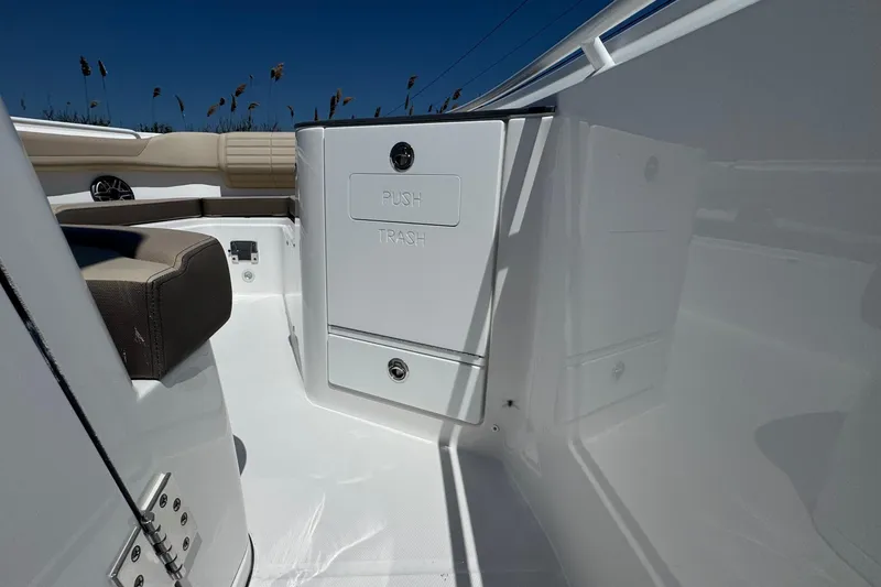 Slide: The Image of 2026 Edgewater 262CC boat interior with trash compartment and seating. - 43