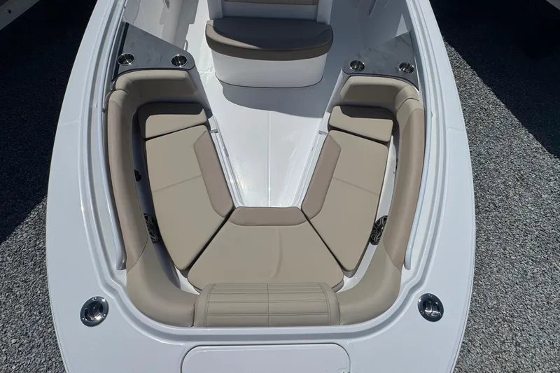 Slide: The Image of 2026 Edgewater 262CC boat with spacious beige seating area and cup holders. - 47