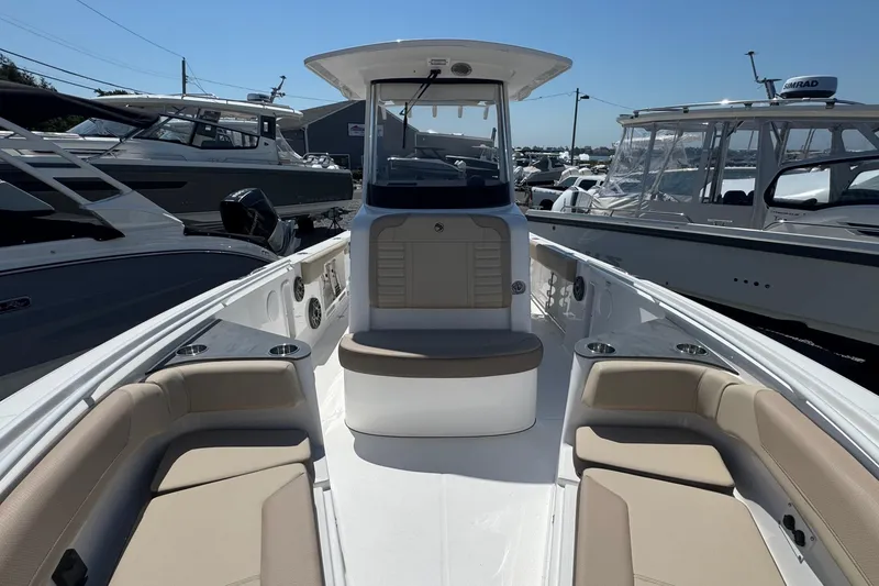 Slide: The Image of 2026 Edgewater 262CC boat interior with beige seating and modern design. - 49