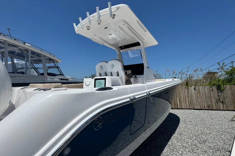 Slide: The Image of 2026 Edgewater 262CC boat with sleek design, showcased outdoors under clear blue sky. - 5
