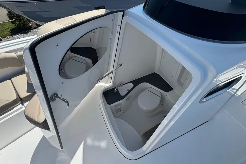 Slide: The Image of Interior view of 2026 Edgewater 262CC boat's compact bathroom with seating. - 50