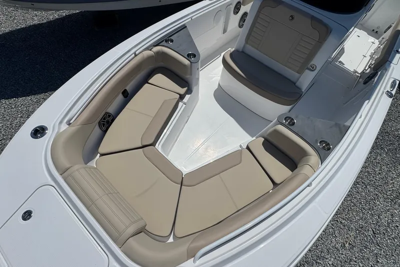 Slide: The Image of Luxurious seating area on 2026 Edgewater 262CC boat, featuring beige cushions and cup holders. - 52