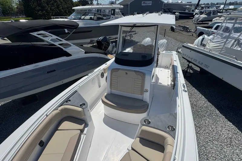Slide: The Image of 2026 Edgewater 262CC boat with sleek design and spacious seating at a marina. - 53