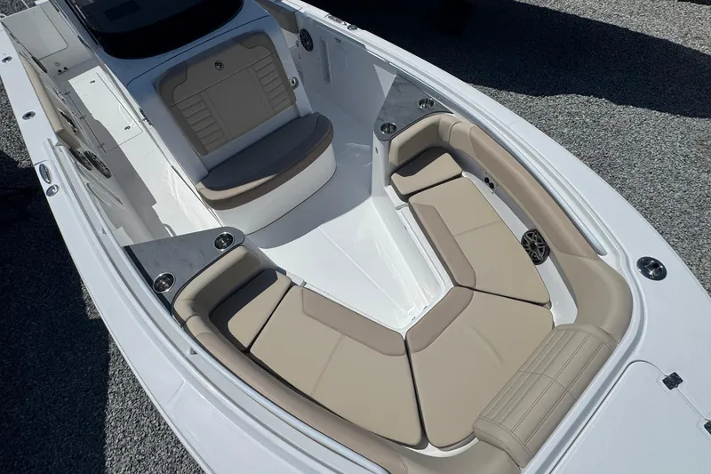 Slide: The Image of 2026 Edgewater 262CC boat interior with beige seating and modern design. - 54