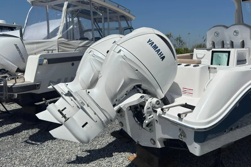 Slide: The Image of Edgewater 262CC 2026 with Yamaha outboard motors on gravel surface. - 7