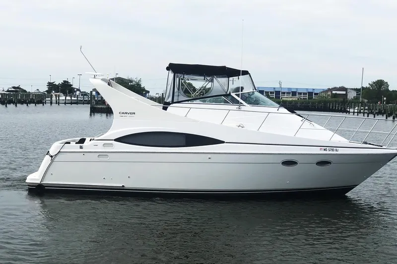 The Image of 2000 Carver 350 Mariner yacht on calm water, featuring sleek white design and spacious deck. - 0