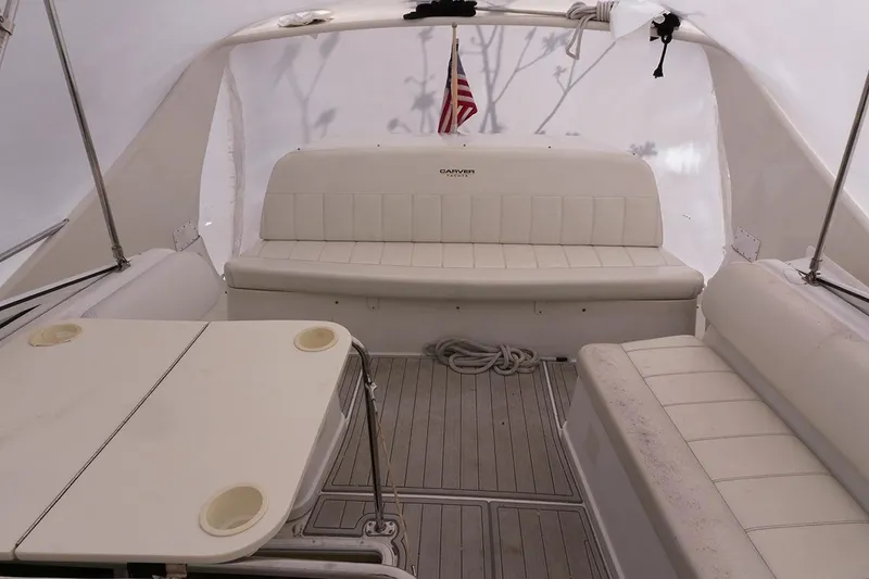 Slide: The Image of Interior of a 2000 Carver 350 Mariner boat with seating and table. - 10