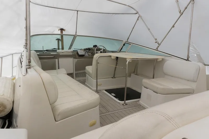 Slide: The Image of Interior view of a 2000 Carver 350 Mariner yacht, featuring white seating and helm. - 12