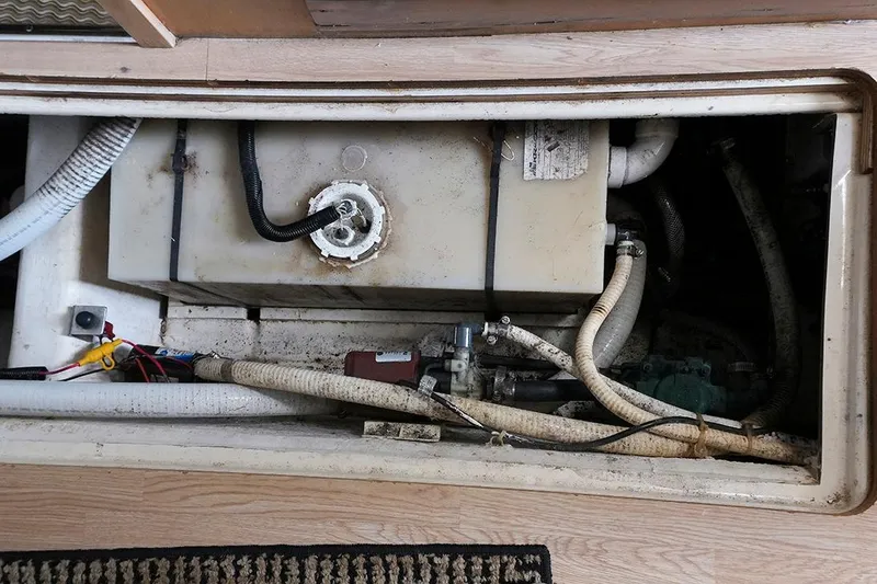 Slide: The Image of Engine compartment of a 2000 Carver 350 Mariner with visible hoses and wiring. - 14