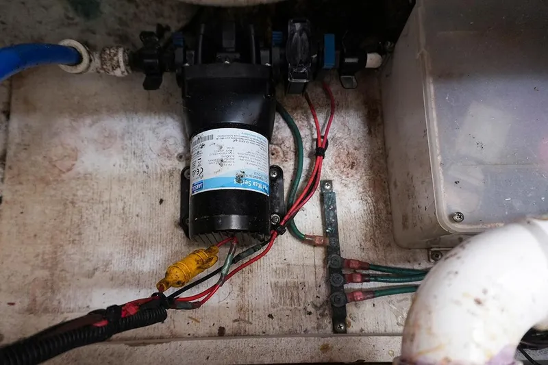 Slide: The Image of Electrical wiring and pump system inside a 2000 Carver 350 Mariner boat. - 15