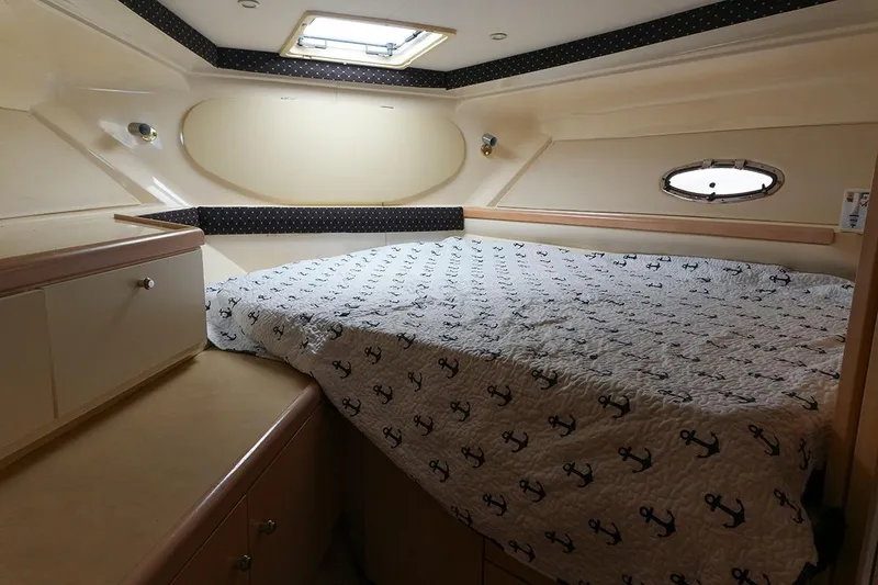 Slide: The Image of Cozy cabin interior of 2000 Carver 350 Mariner with anchor-patterned bedding. - 17