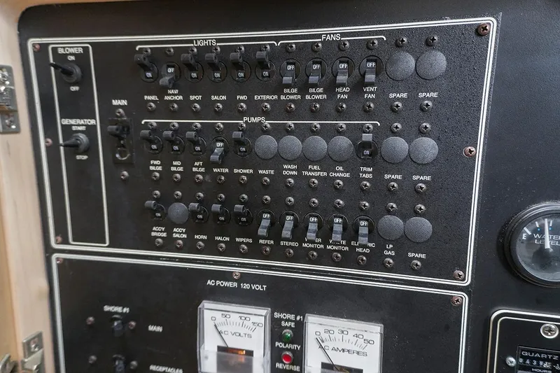 Slide: The Image of Control panel of a 2000 Carver 350 Mariner boat with switches and gauges. - 19