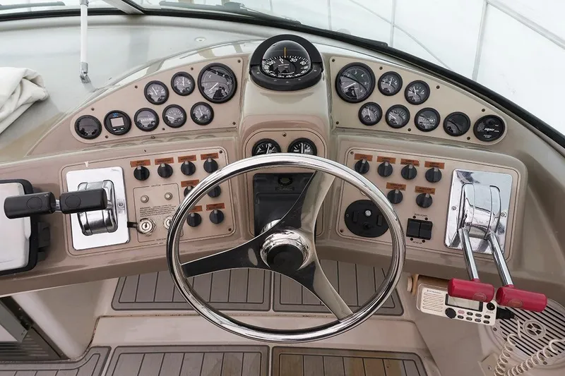 Slide: The Image of Helm of 2000 Carver 350 Mariner with gauges, controls, and steering wheel. - 2