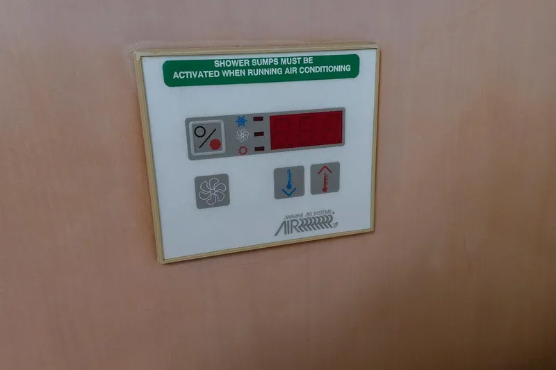 Slide: The Image of Control panel on a 2000 Carver 350 Mariner, featuring air conditioning settings. - 22