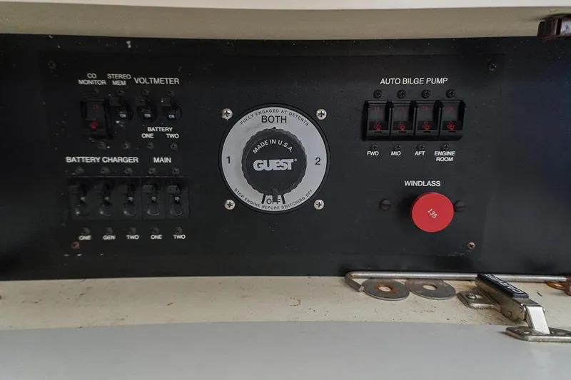 Slide: The Image of Control panel of a 2000 Carver 350 Mariner boat with various switches and gauges. - 23