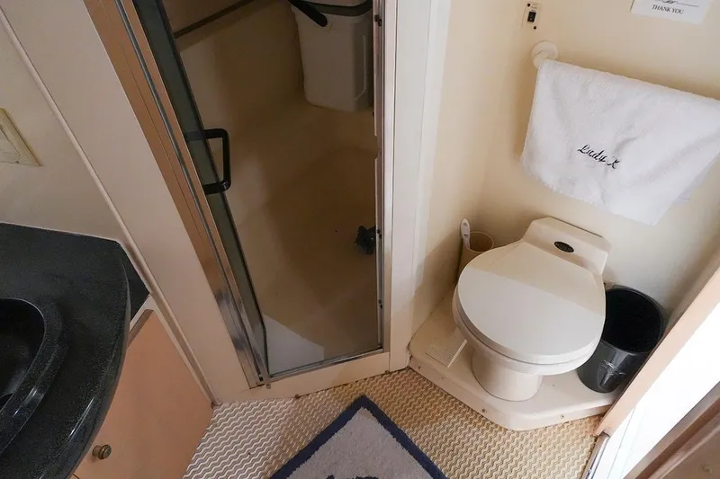 Slide: The Image of Bathroom interior of 2000 Carver 350 Mariner yacht, featuring toilet and shower. - 27