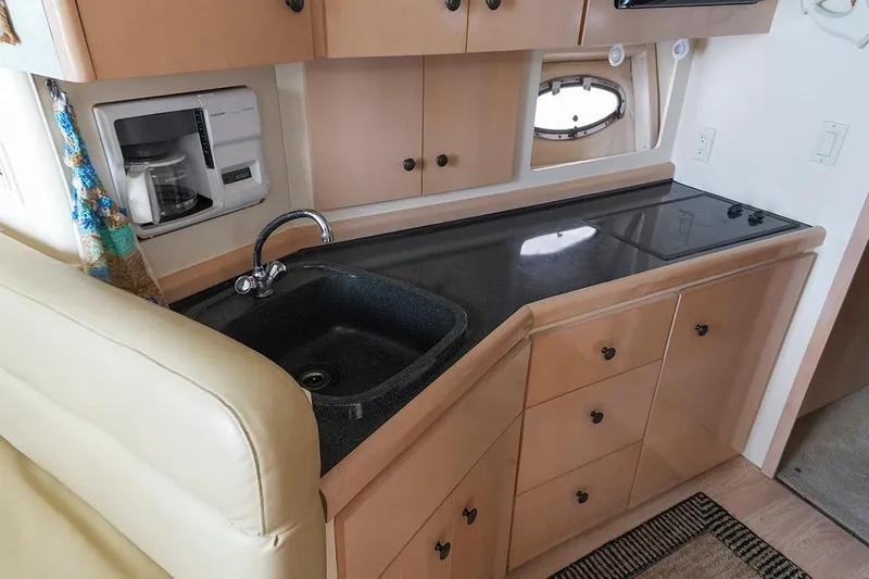Slide: The Image of Compact kitchen area in a 2000 Carver 350 Mariner yacht with sink and stove. - 28