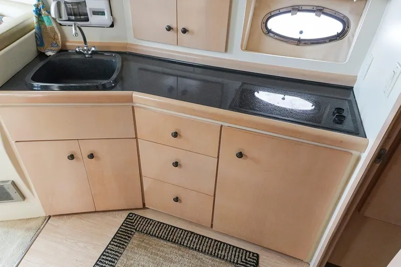 Slide: The Image of 2000 Carver 350 Mariner kitchen with sink, stove, and storage cabinets. - 30