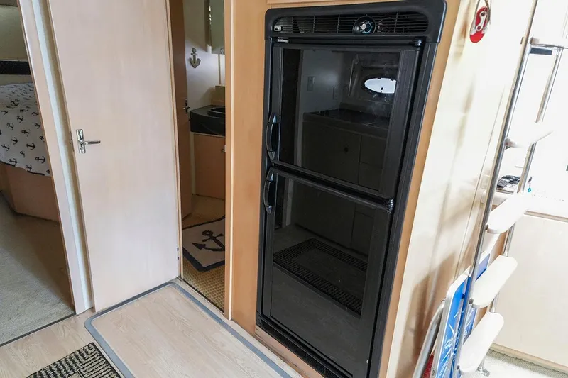 Slide: The Image of Interior of 2000 Carver 350 Mariner yacht with refrigerator and nautical decor. - 31