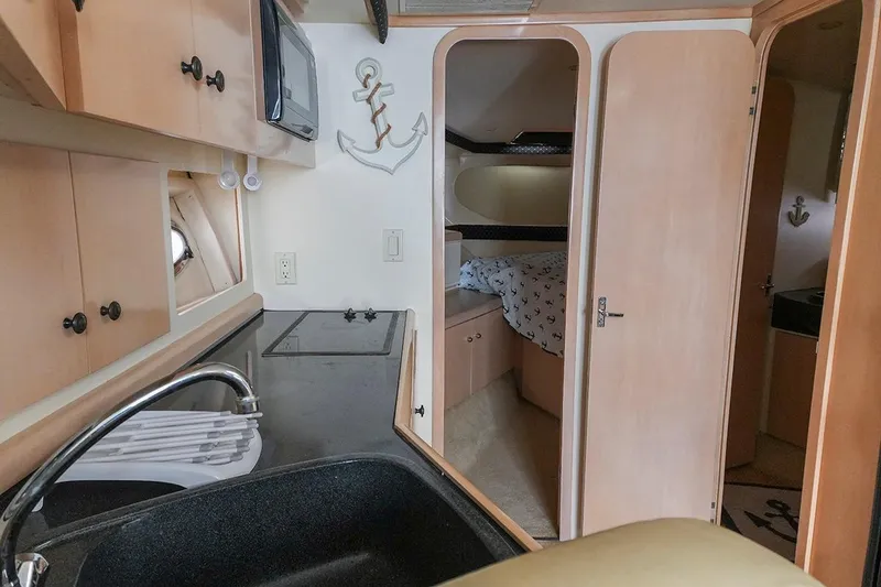 Slide: The Image of Interior of 2000 Carver 350 Mariner yacht with kitchenette and cozy sleeping area. - 32