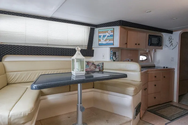 Slide: The Image of Interior of 2000 Carver 350 Mariner yacht with cozy seating and kitchenette. - 33