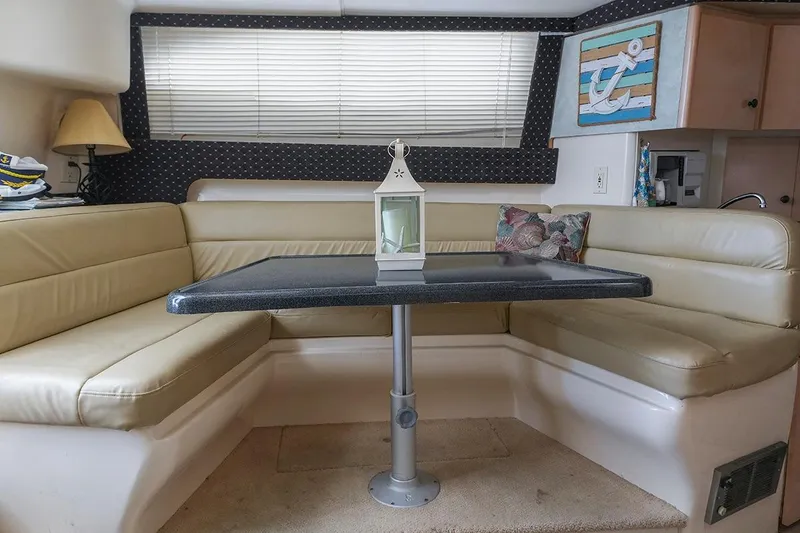 Slide: The Image of Interior of a 2000 Carver 350 Mariner yacht with a cozy dining area. - 34