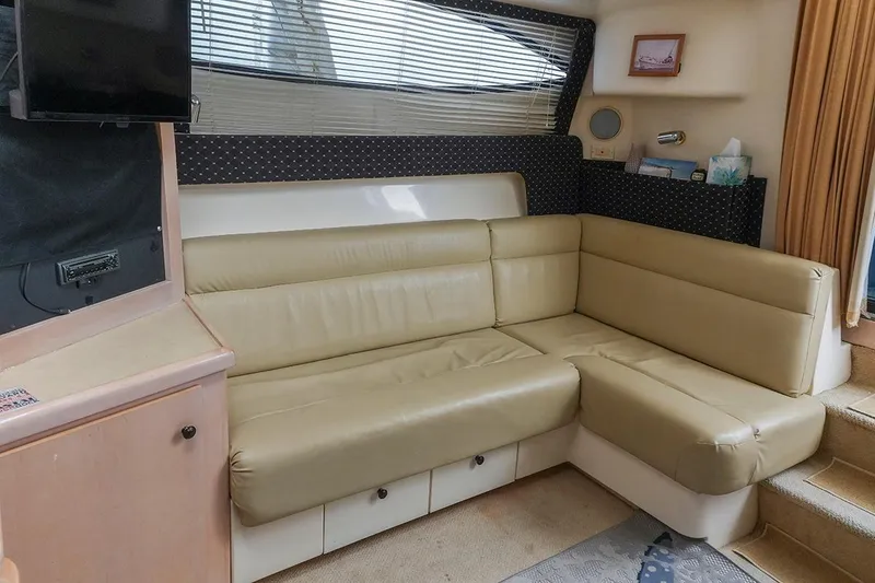 Slide: The Image of Interior of a 2000 Carver 350 Mariner yacht with beige leather seating. - 35