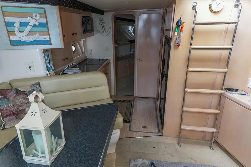 Slide: The Image of Interior of a 2000 Carver 350 Mariner yacht with nautical decor and ladder. - 36