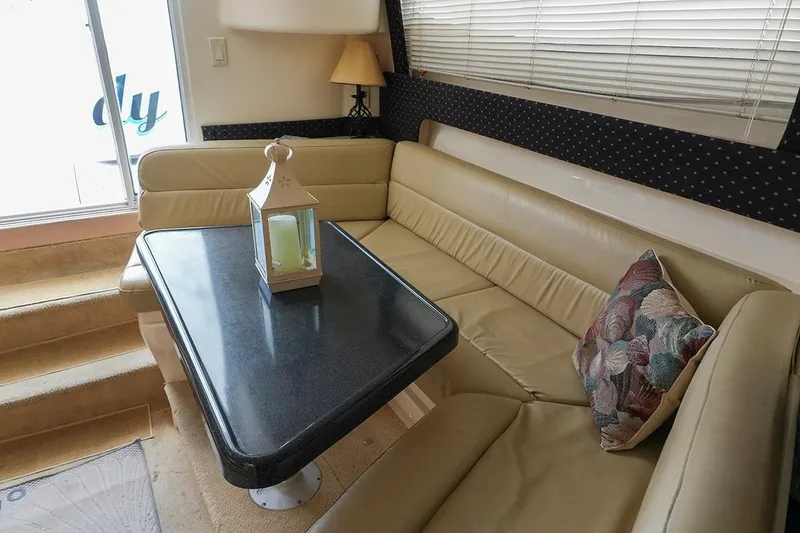 Slide: The Image of Interior of 2000 Carver 350 Mariner yacht with cozy seating and decorative lantern. - 37