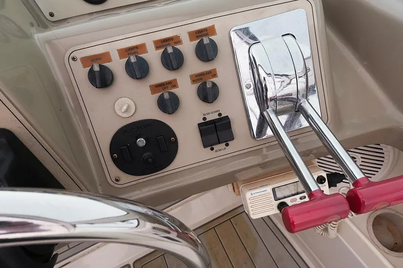 Slide: The Image of Control panel of a 2000 Carver 350 Mariner boat with throttle levers and switches. - 4